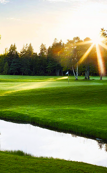Sunrise on a golf course with water